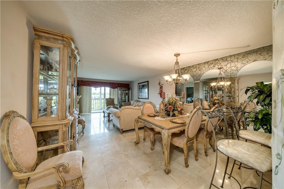 3955 North Nob Hill Road, Unit 408 Sunrise, FL 33351 - Photo 3 of 34 a view of a dining room with furniture window and outside view