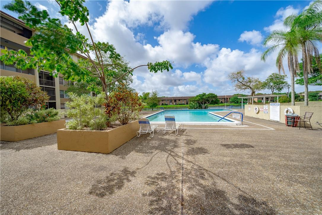 3955 North Nob Hill Road, Unit 408 Sunrise, FL 33351 - Photo 32 of 34 an outdoor view with garden