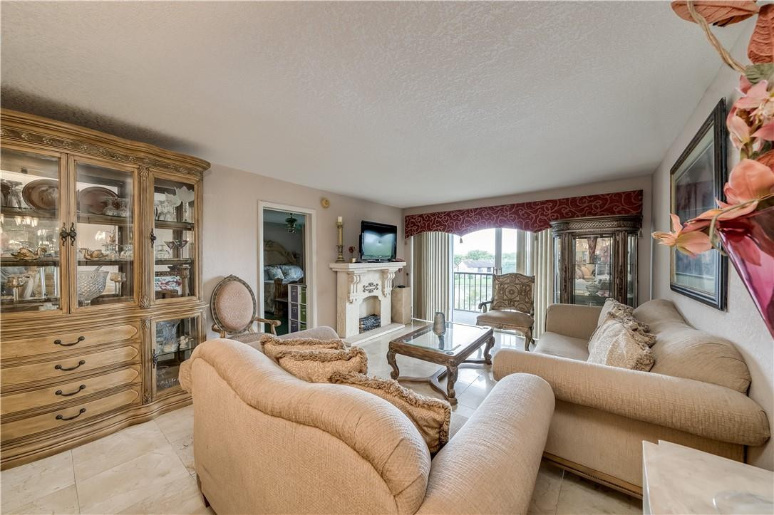 3955 North Nob Hill Road, Unit 408 Sunrise, FL 33351 - Photo 5 of 34 a living room with furniture and a floor to ceiling window