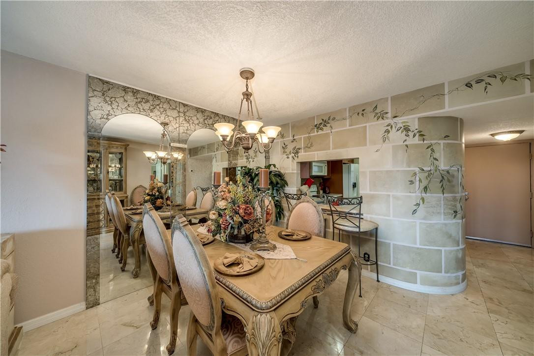 3955 North Nob Hill Road, Unit 408 Sunrise, FL 33351 - Photo 6 of 34 a view of a dining room with furniture and a chandelier