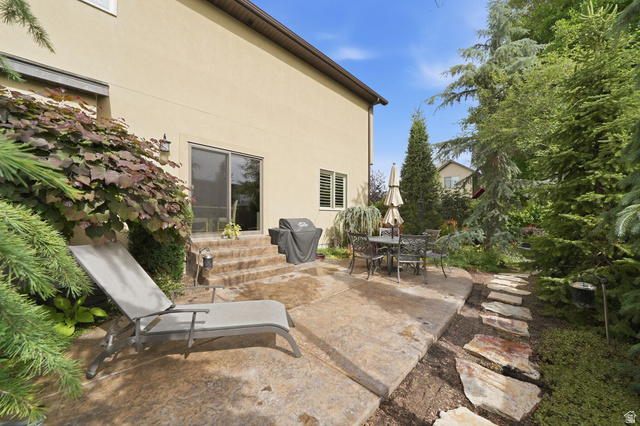 7253 Viansa Court Midvale, UT 84047 - Photo 45 of 45 Stucco exterior with a concrete patio featuring steps to a sliding glass door
