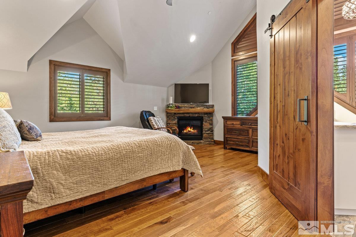 2204 Lands End Road Glenbrook, NV 89413 - Photo 12 of 40 a spacious bedroom with a bed and a flat screen tv