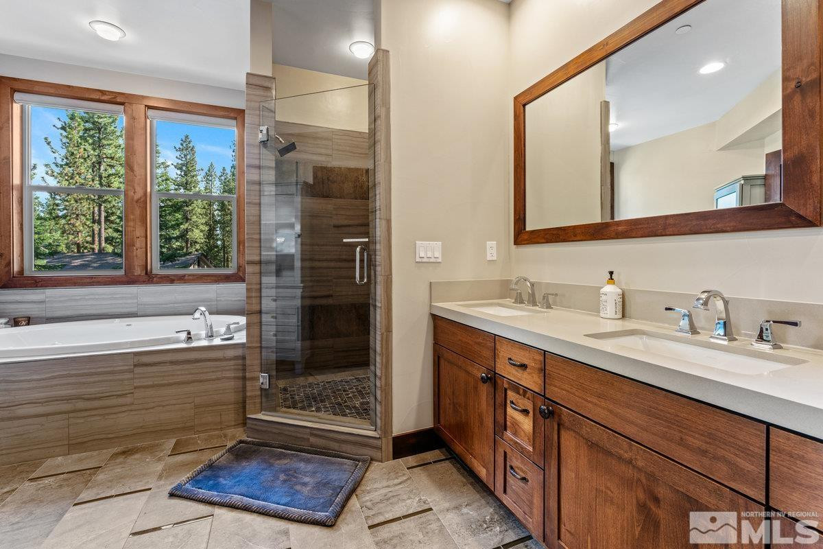 2204 Lands End Road Glenbrook, NV 89413 - Photo 17 of 40 a bathroom with a sink a large mirror and a shower