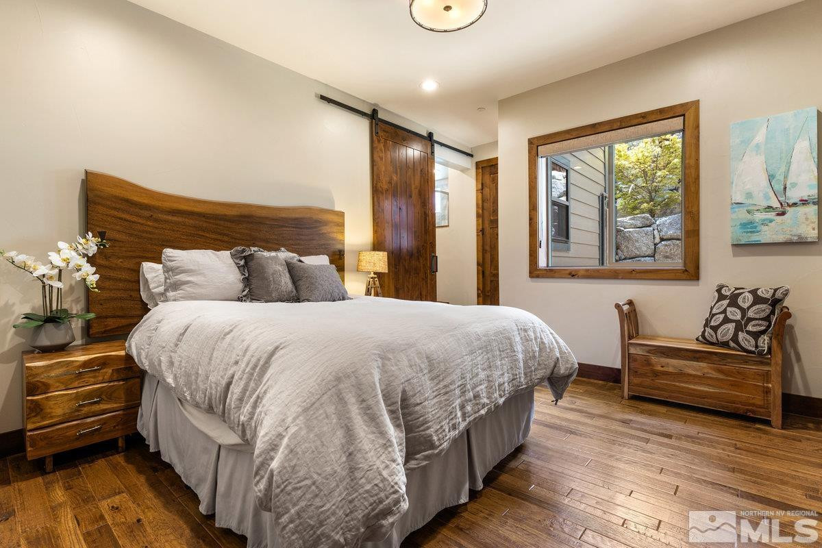 2204 Lands End Road Glenbrook, NV 89413 - Photo 27 of 40 a bedroom with a bed and wooden floor