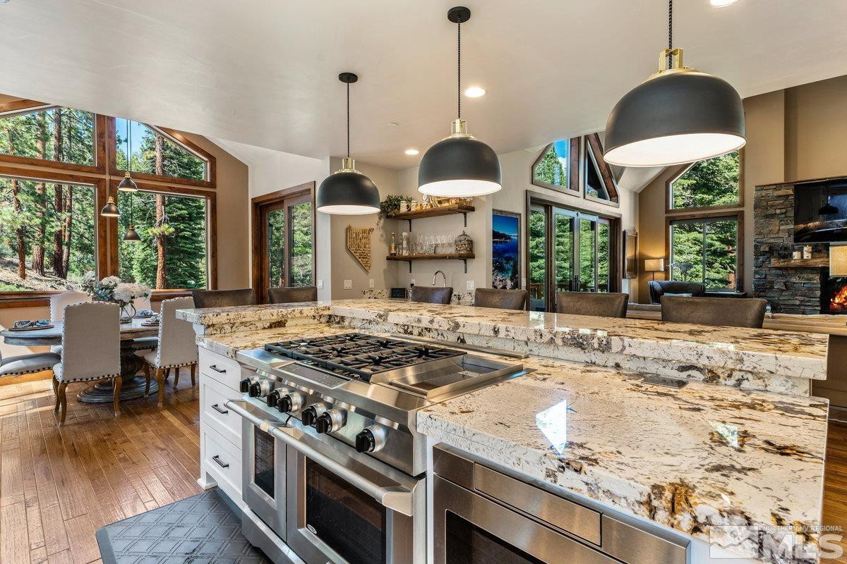 2204 Lands End Road Glenbrook, NV 89413 - Photo 8 of 40 a kitchen with stainless steel appliances granite countertop a stove a sink a oven and a large window