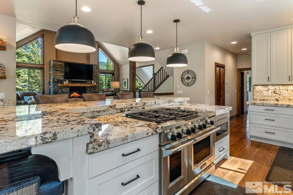 2204 Lands End Road Glenbrook, NV 89413 - Photo 9 of 40 a kitchen with stainless steel appliances granite countertop a stove and a wooden floor