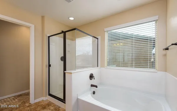 a bathroom with a double vanity sink and mirror with shower