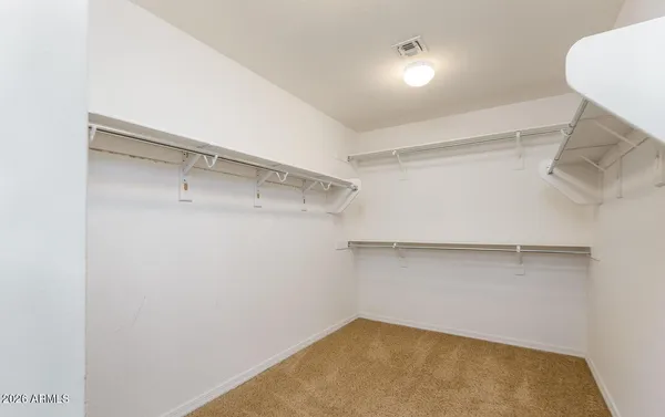 an empty room with a window and a ceiling fan