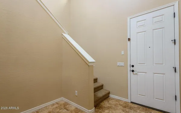 a view of a hallway with a kitchen and a window