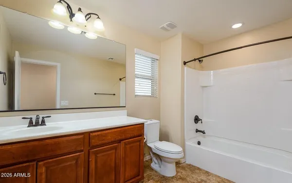 wooden floor in kitchen and a room with a ceiling fan