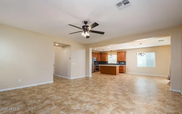 a kitchen with stainless steel appliances granite countertop a refrigerator and a stove top oven