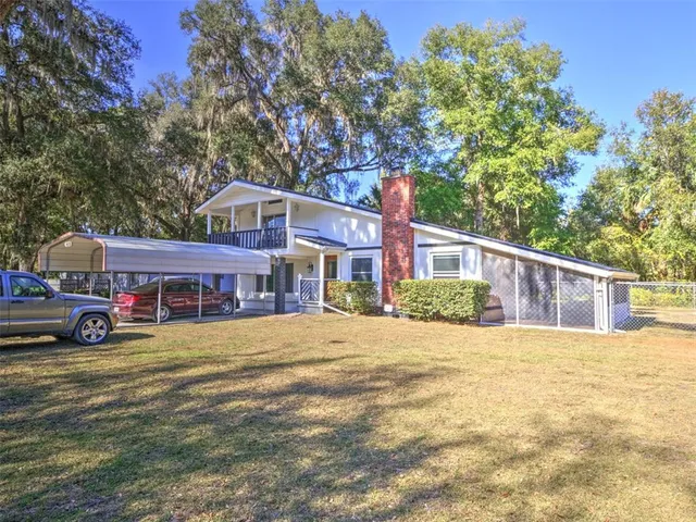 a view of house with yard and entertaining space