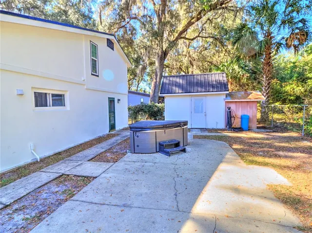 a view of a house with snow on the side of the road