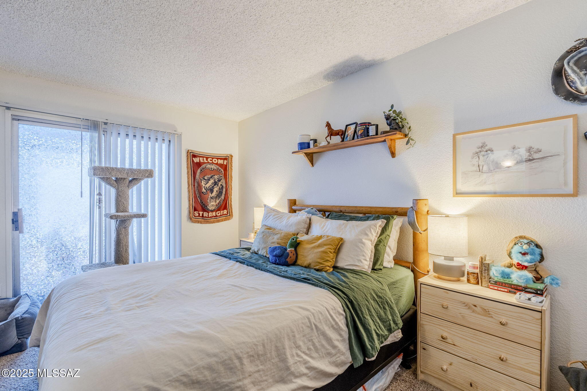 1131 West Roger Road Tucson, AZ 85705 - Photo 15 of 26 a bedroom with bed and wooden floor