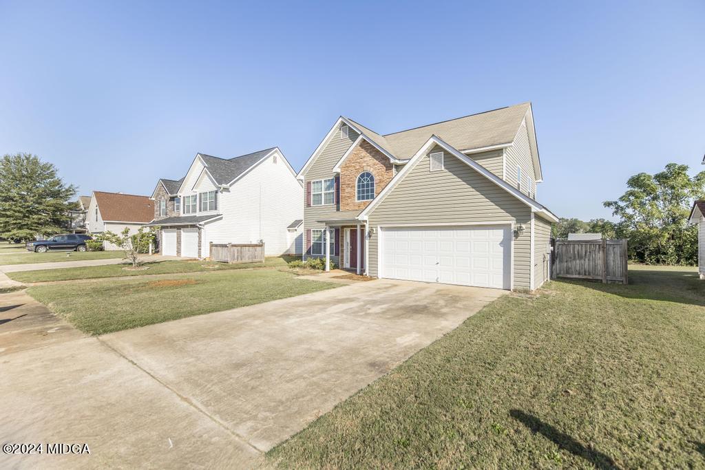 307 Timberwind Drive Byron, GA 31008 - Photo 2 of 27 a view of house next to a yard with large trees
