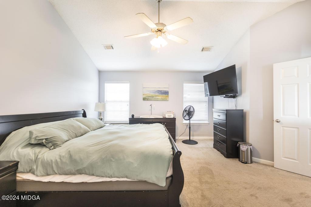 307 Timberwind Drive Byron, GA 31008 - Photo 21 of 27 a bedroom with a bed and a flat tv screen on the dresser