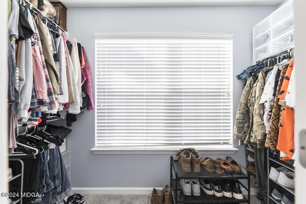 307 Timberwind Drive Byron, GA 31008 - Photo 24 of 27 a view of walk in closet with clothes and shoes