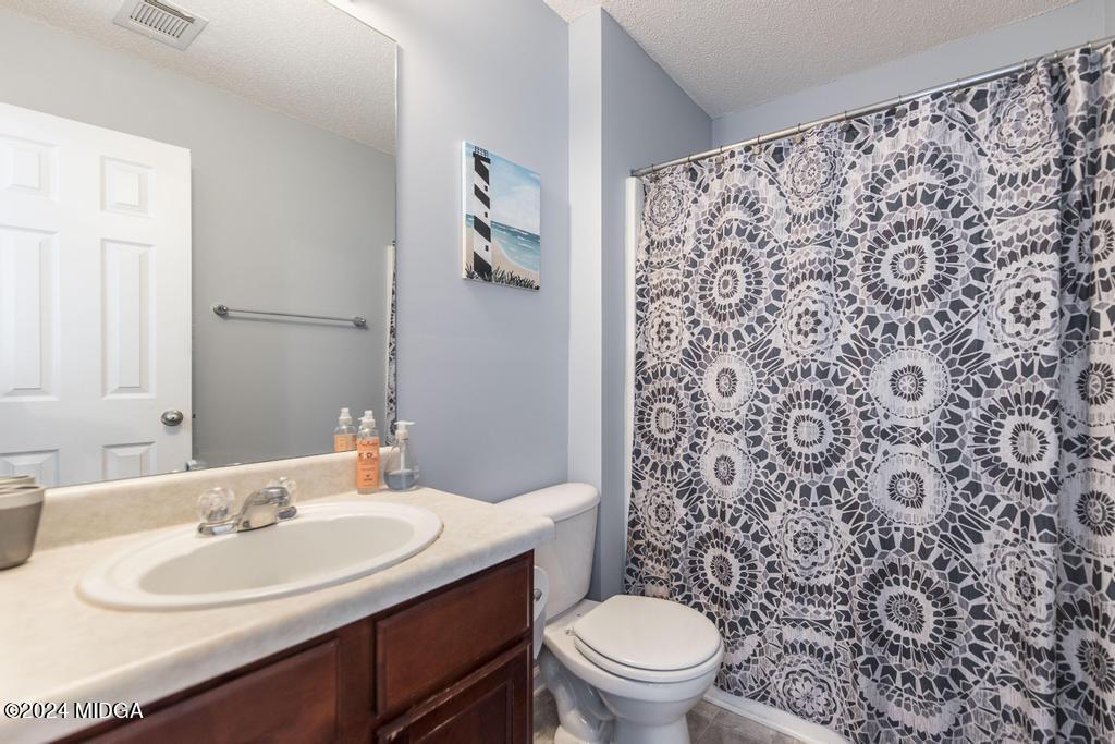 307 Timberwind Drive Byron, GA 31008 - Photo 27 of 27 a bathroom with a sink toilet and a mirror