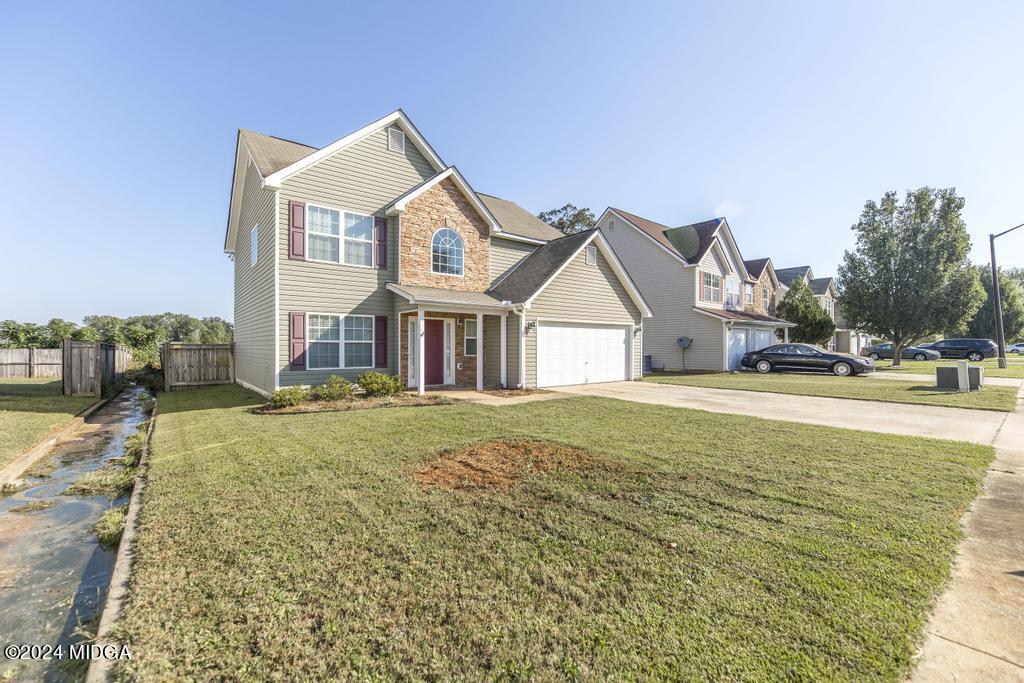 307 Timberwind Drive Byron, GA 31008 - Photo 4 of 27 a front view of a house with a yard
