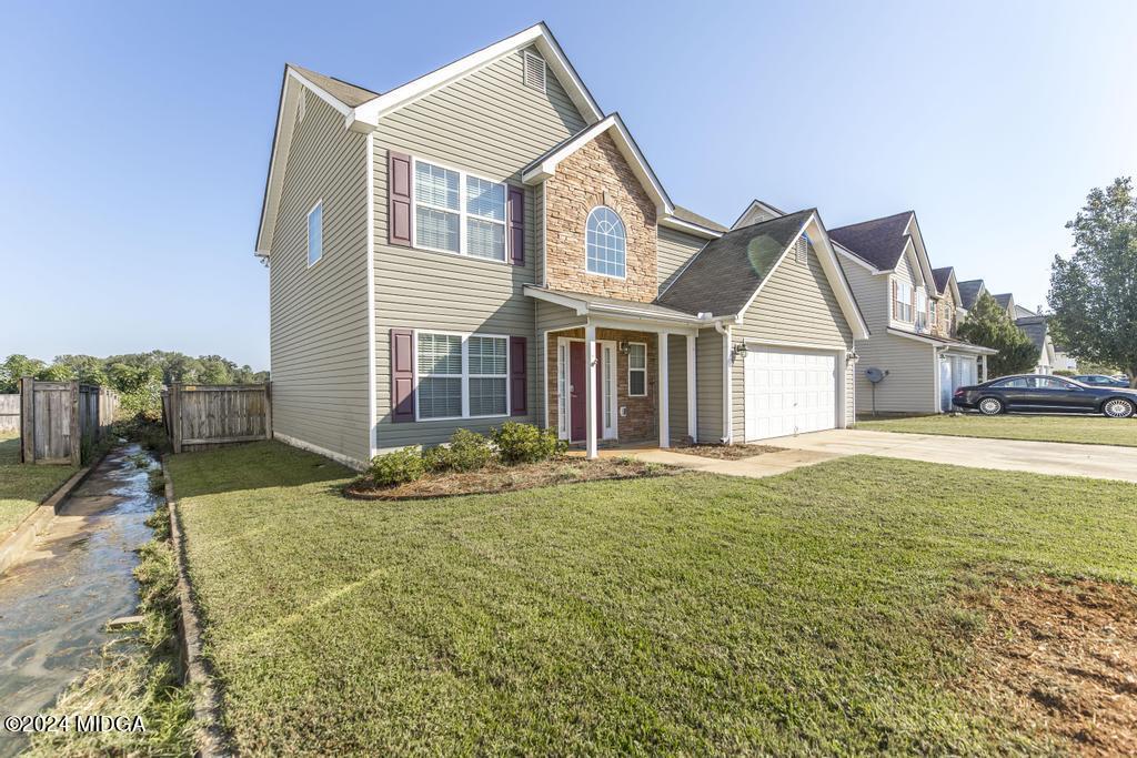 307 Timberwind Drive Byron, GA 31008 - Photo 5 of 27 a front view of a house with a yard