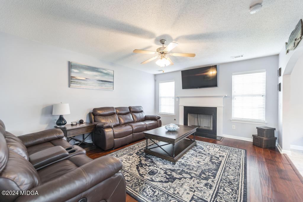 307 Timberwind Drive Byron, GA 31008 - Photo 9 of 27 a living room with furniture a flat screen tv and a fireplace