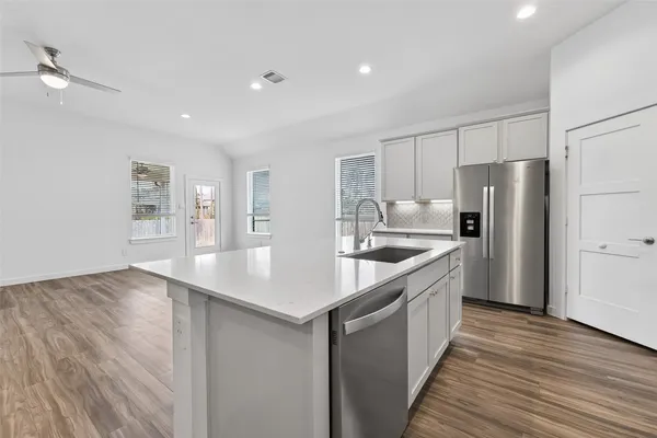 a kitchen with a sink a refrigerator and window