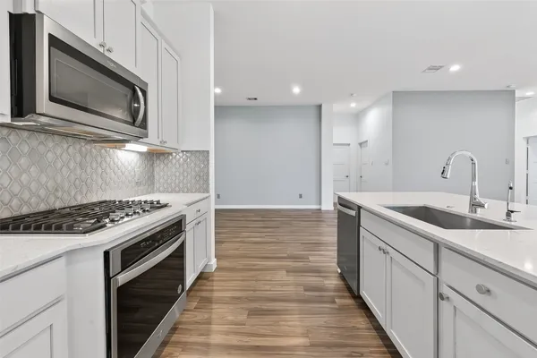 a kitchen with a stove and a microwave