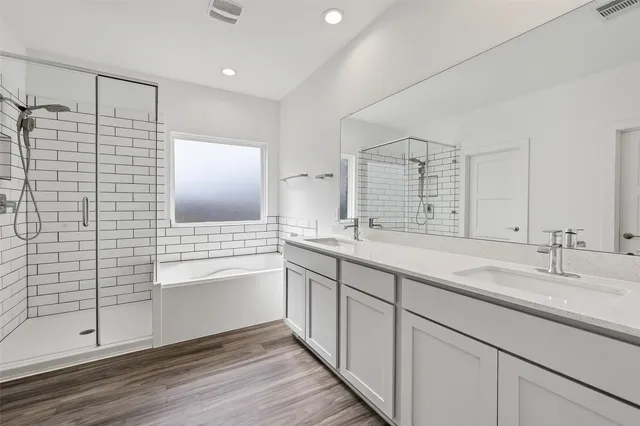 a bathroom with a shower sink and mirror