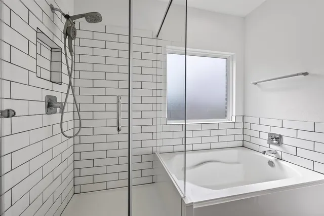 a bathroom with a shower and a sink