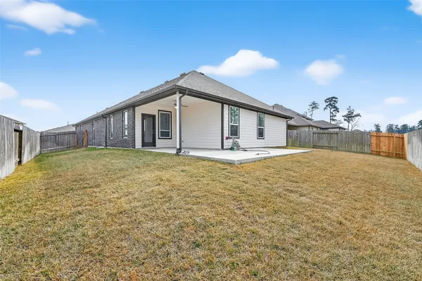 a view of a house with a backyard