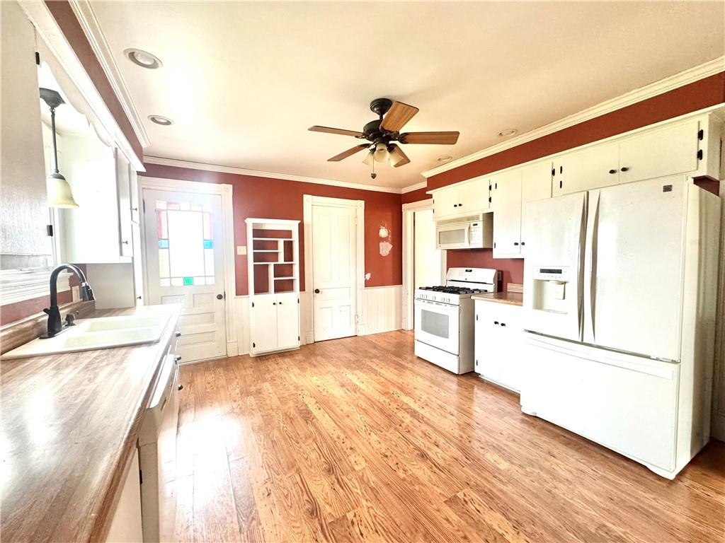3282 Hann Hill Road Hermitage, PA 16148 - Photo 12 of 41 a large kitchen with stainless steel appliances kitchen island granite countertop a refrigerator a stove a sink dishwasher and white countertops with wooden floor
