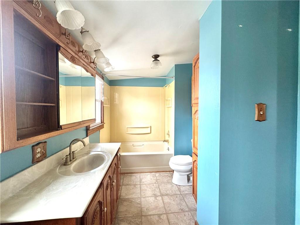 3282 Hann Hill Road Hermitage, PA 16148 - Photo 33 of 41 a bathroom with a granite countertop sink a toilet a mirror and shower