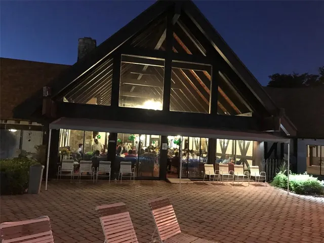 a view of a building with porch and wooden floor