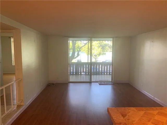 a view of an empty room and wooden floor
