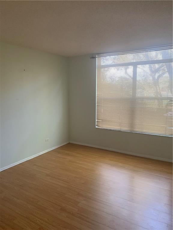 3710 Inverrary Drive, Unit 2U Lauderhill, FL 33319 - Photo 16 of 17 an empty room with wooden floor and windows