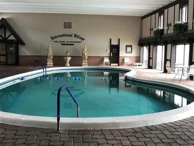 a kitchen with a sink a counter and chairs