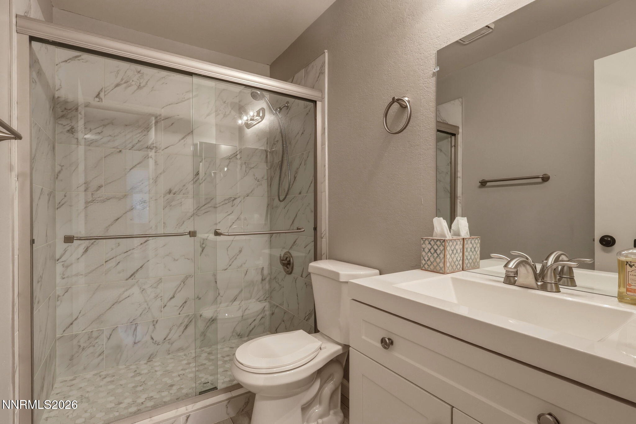 4557 Reggie Road Reno, NV 89502 - Photo 11 of 25 a bathroom with a sink mirror vanity and toilet