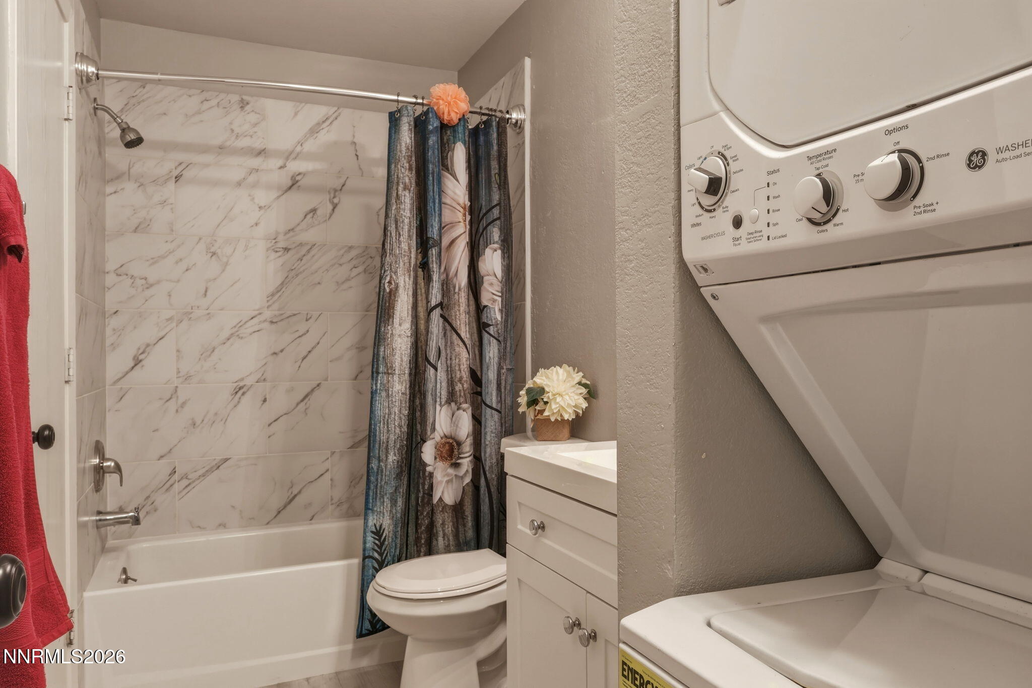 4557 Reggie Road Reno, NV 89502 - Photo 13 of 25 a bathroom with a toilet and a shower curtain