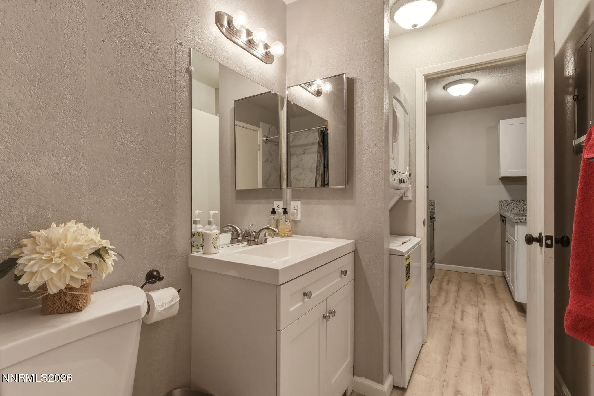 4557 Reggie Road Reno, NV 89502 - Photo 15 of 25 a bathroom with a sink a toilet and a mirror