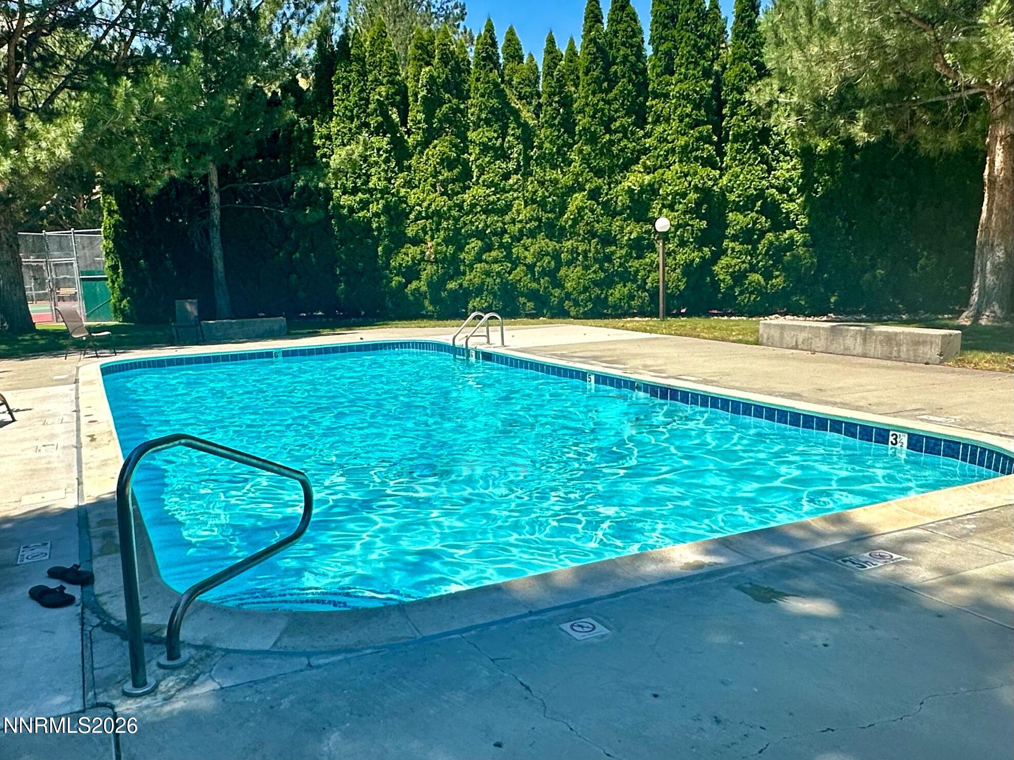 4557 Reggie Road Reno, NV 89502 - Photo 18 of 25 a view of a swimming pool with a patio and a yard