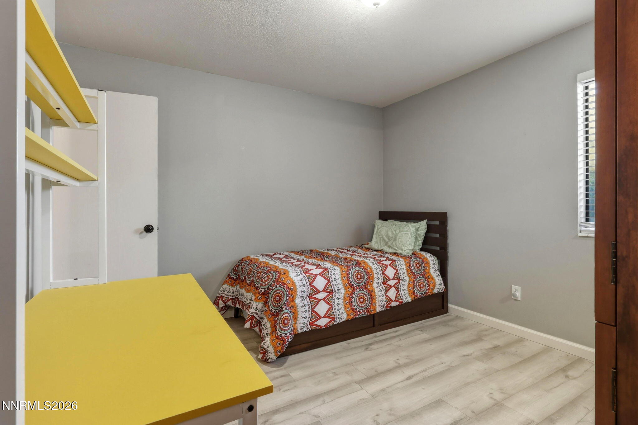 4557 Reggie Road Reno, NV 89502 - Photo 4 of 25 a bedroom with a bed and a window