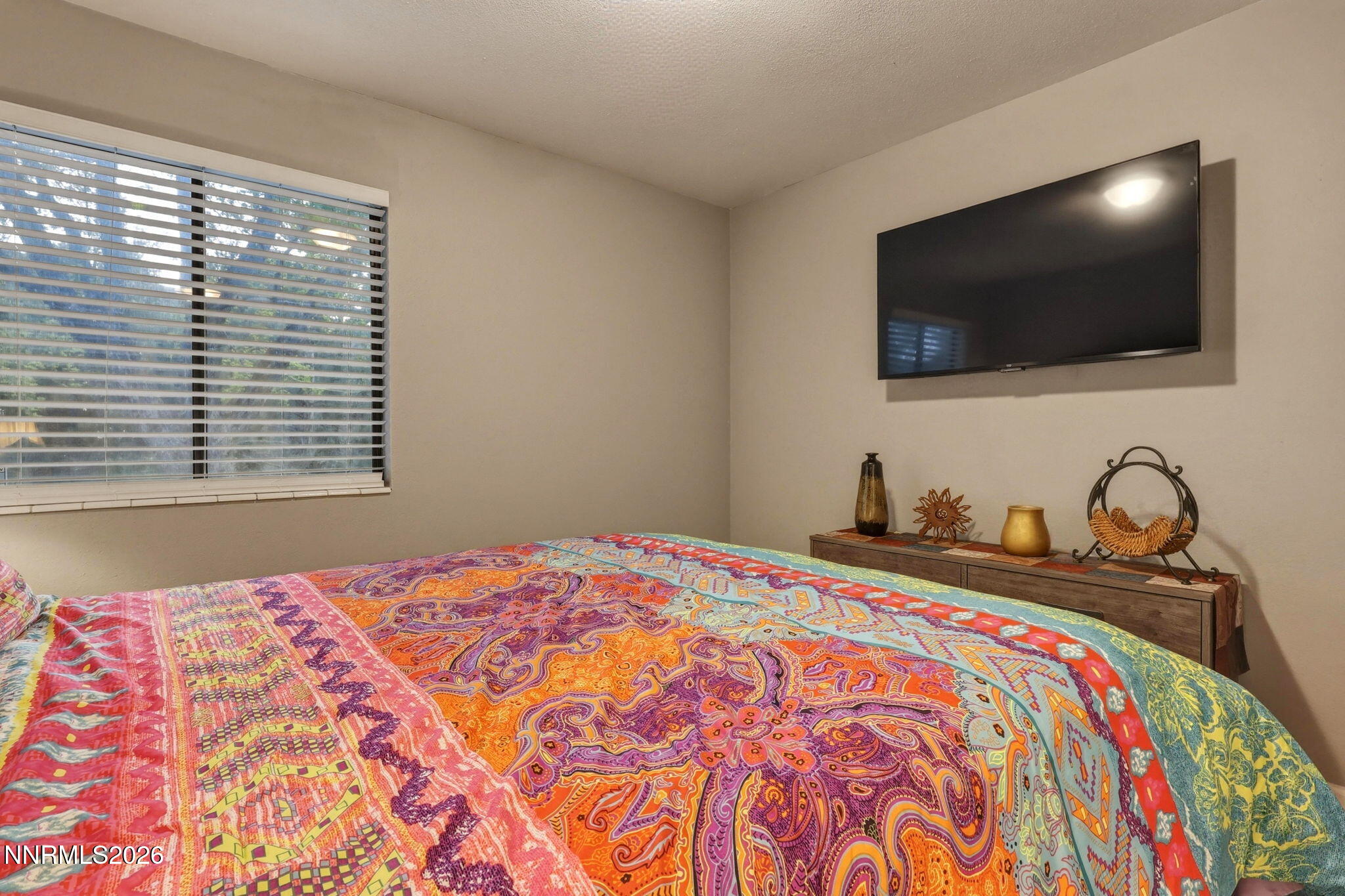 4557 Reggie Road Reno, NV 89502 - Photo 6 of 25 a bedroom with a bed and a flat screen tv