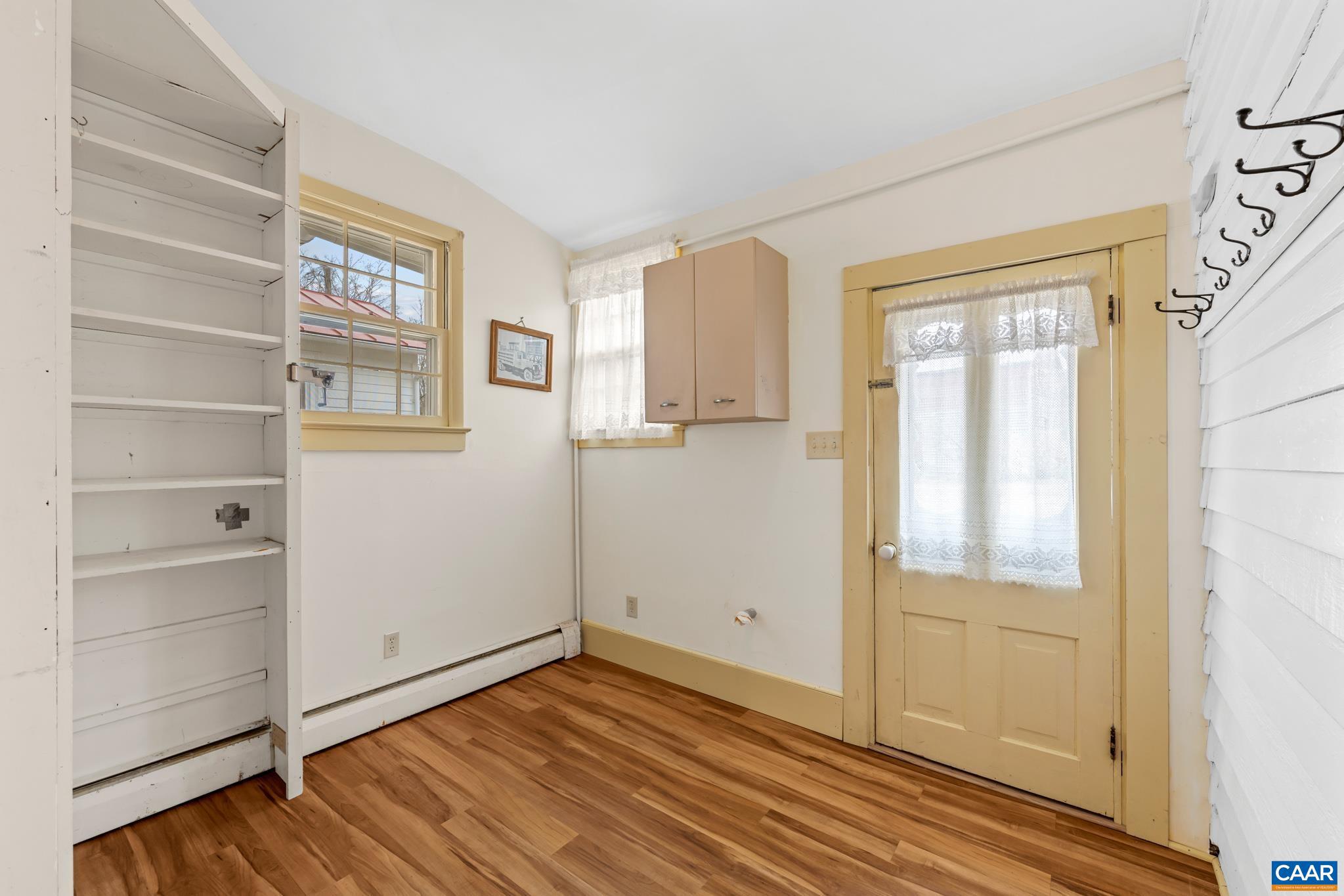9451 Black Walnut Run Road Rhoadesville, VA 22542 - Photo 32 of 72 a view of empty room with wooden floor and entryway