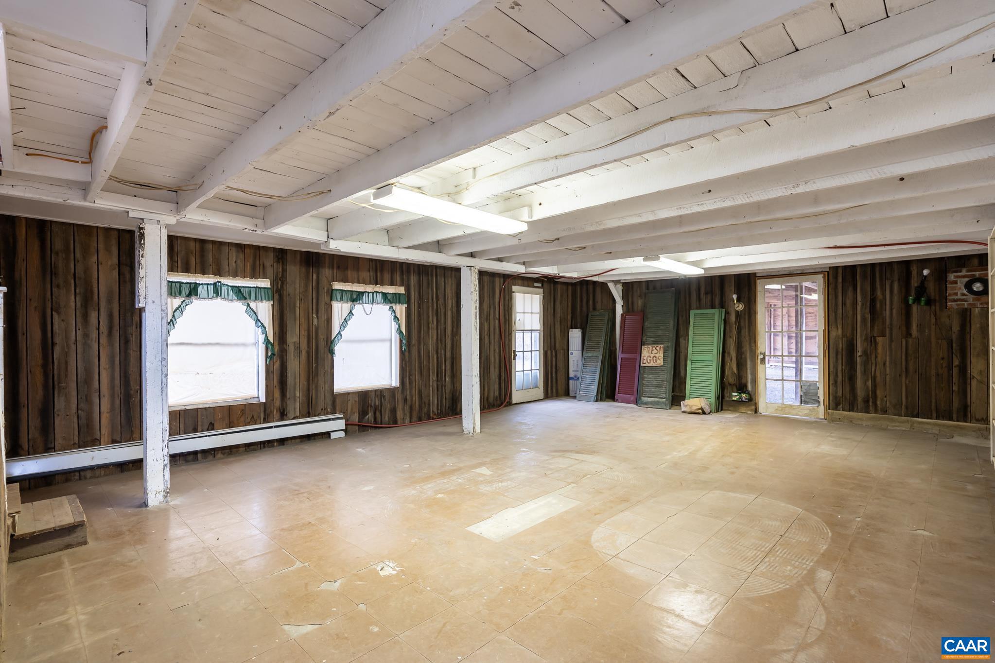 9451 Black Walnut Run Road Rhoadesville, VA 22542 - Photo 56 of 72 a view of an empty room with large windows