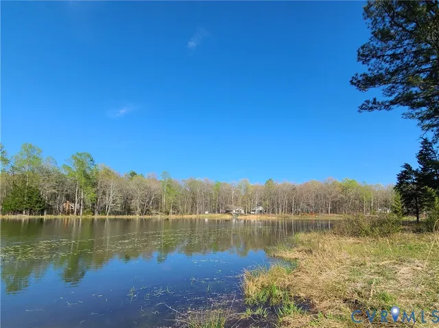 an aerial view of a house with lake view