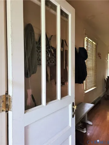 a view of hallway with livingroom and wooden floor