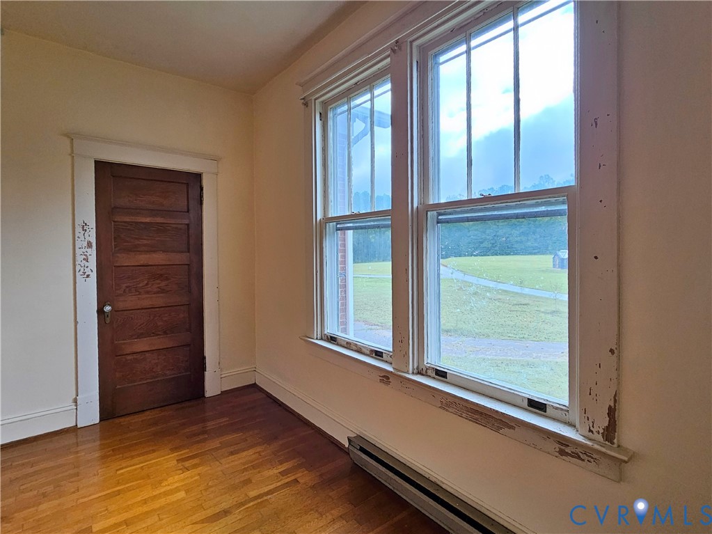 16124 Beaverdam School Road Beaverdam, VA 23015 - Photo 32 of 50 an empty room with wooden floor and windows