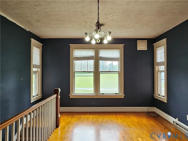 a dining room with furniture and wooden floor