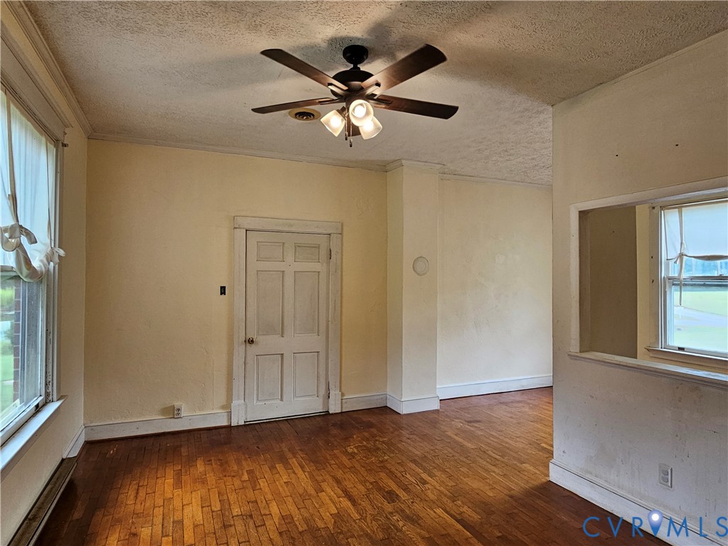 16124 Beaverdam School Road Beaverdam, VA 23015 - Photo 38 of 50 an empty room with wooden floor fan and windows