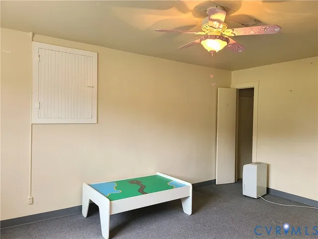 a bedroom with furniture and a closet